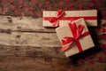 Conceptual image of Happy Saint valentines day wrapped gifts and red hearts on wooden vintage table