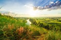 A beautiful valley with a river, blue sky with large clouds and bright sun. Aerial Royalty Free Stock Photo