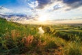 A beautiful valley with a river, blue sky with large clouds and bright sun. Aerial Royalty Free Stock Photo