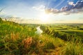 A beautiful valley with a river, blue sky with large clouds and bright sun. Aerial Royalty Free Stock Photo