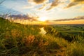 A beautiful valley with a river, blue sky with large clouds and bright sun. Aerial Royalty Free Stock Photo