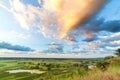 A beautiful valley with a river, blue sky with large clouds and bright sun. Aerial 4K UHD Royalty Free Stock Photo