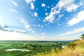 A beautiful valley with a river, blue sky with large clouds and bright sun. Aerial 4K UHD Royalty Free Stock Photo