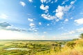 A beautiful valley with a river, blue sky with large clouds and bright sun. Aerial 4K UHD Royalty Free Stock Photo