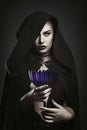 Beautiful vampire holding a cup Royalty Free Stock Photo