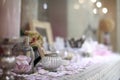 Beautiful vanity with purple flower petals and perfume bottles.