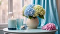 Beautiful vase with hydrangea flowers, gift box on table bouquet
