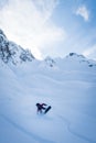 Beautiful vertical picture of a sportsman carving on a snowboard on the snowy slope