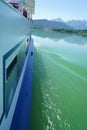 Beautiful vertical shot of a distant landscape from side view of a ferry boat