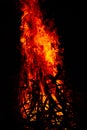 Beautiful vertical shot of a large burning fire at night Royalty Free Stock Photo