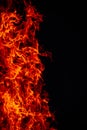 Beautiful vertical shot of a large burning fire at night Royalty Free Stock Photo