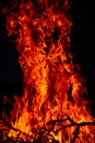 Beautiful vertical shot of a large burning fire at night Royalty Free Stock Photo