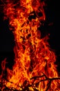 Beautiful vertical shot of a large burning fire at night Royalty Free Stock Photo