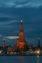 Beautiful vertical view of famous Wat Arun, the Buddhist temple of dawn, in the light of the blue hour after sunset, Bangkok