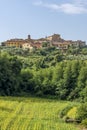 Beautiful vertical view of the picturesque Tuscan village of Lari, Pisa, Italy, with a field of sunflowers below Royalty Free Stock Photo