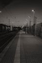 Beautiful vertical view of a road by train railways at night