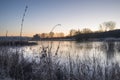 Beautiful vibrant English countryside lake image with frost and Royalty Free Stock Photo