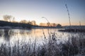 Beautiful vibrant English countryside lake image with frost and Royalty Free Stock Photo