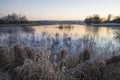 Beautiful vibrant English countryside lake image with frost and Royalty Free Stock Photo