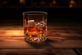 A glass of whiskey on a wooden table