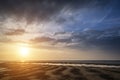 Beautiful vibrant Summer sunset over golden beach landscape