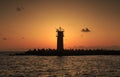 Beautiful Vibrant Sunrise Sky Over Calm Sea Water And Lighthouse