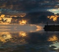 Beautiful vibrant sunrise sky over calm water ocean with lighthouse and harbor wall Royalty Free Stock Photo