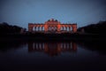 Beautiful vibrant sunset over the river Seine in Paris, France, with a tourist canalboat under an arched bridge and the