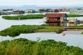 Beautiful Vietnamese fishing village on Dong Nai river, floating house, fishing tank, water hyacinth Royalty Free Stock Photo