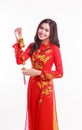 Beautiful Vietnamese woman with red ao dai holding lucky new year ornament Royalty Free Stock Photo