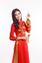 Beautiful Vietnamese woman with red ao dai holding lucky new year ornament Royalty Free Stock Photo