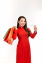 Beautiful Vietnamese young girl holding and posing with shopping bags on a white background Royalty Free Stock Photo