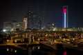 Beautiful view of Abu Dhabi city famous landscape displaying UAE flag, Etihad towers and Marina boats at night Royalty Free Stock Photo