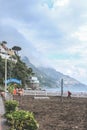 Beautiful view of Amalfi coast and `L`Incanto Bar Ristorante` on the beachfront in Italy