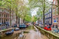 Amsterdam, Netherlands. View of the canal, boats and medieval typical Dutch houses in a spring day. Royalty Free Stock Photo