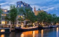 Beautiful view of Amsterdam canals with bridge and typical dutch houses. Holland Royalty Free Stock Photo