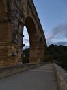 Beautiful view of ancient Roman aqueduct Pont du Gard in the evening near Vers-Pont-du-Gard, Occitanie, France. Royalty Free Stock Photo