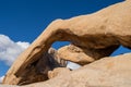 Beautiful view of Arch Rock in Joshua Tree National Park. Late Afternoon sunshine against blue sky