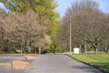 Beautiful view of asphalt road with spring trees along it, and road sign of maximum allowable speed of 20 km per hour in Howth