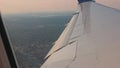 Beautiful view of the Atlantic coastline landscape under the aircraft wing with moving wingtips during the flight