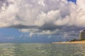 Beautiful view of Atlantic Ocean and Miami Beach coastline under havy white clouds on blue sky.