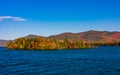 Beautiful view of  autumn trees in the middle of Lake George coast under a blue sky Royalty Free Stock Photo