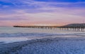 Beautiful view of the Avila beach pier with low tides under a purple-blue sky at sunset Royalty Free Stock Photo