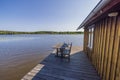 Beautiful view of backyard of villa located on lake with old wooden patio. Royalty Free Stock Photo