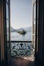 Beautiful view from balcony window at Lago Maggiore and Borromean Islands in sunny light, exploring Italy. Old architecture