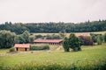 Beautiful view of the barns on the grassy hills under the cloudy sky