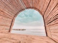 Beautiful view of the beach through a straw shelter