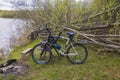 Beautiful view of bicycle parked on shore of lake on spring day for outdoor recreation.