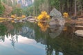 Beautiful view of big rocks and fall trees with reflection in Merced River of Yosemite Royalty Free Stock Photo
