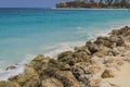 Beautiful view of big rocks protecting sandy coastline. Turqouse water of Atlantic Ocean. Royalty Free Stock Photo